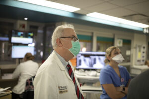 William G. Powderly, MD, discusses patient conditions in the intensive care unit ICU with clinical care staff, including Maanasi Samant, MD, and Praveen Chenna, MD, at Barnes Jewish Hospital during the covid-19 coronavirus pandemic on October 1, 2020.