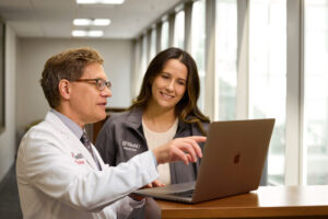 Steven J. Lawrence, MD, a professor of medicine and an assistant dean for curriculum at WashU Medicine, collaborates with Quinn Payton, a fourth-year medical student