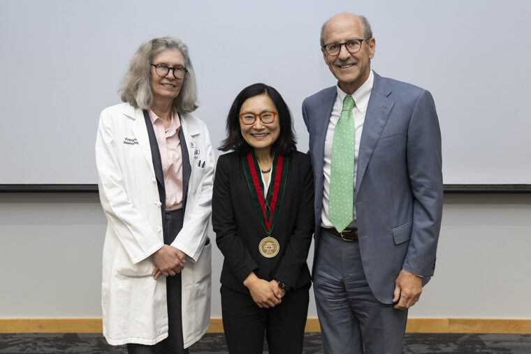Janet S. Lee, MD (middle), a physician-scientist internationally recognized for groundbreaking research in acute lung injury, has been named the inaugural Selma and Herman Seldin Distinguished Professor of Medicine at WashU Medicine. Victoria J. Fraser, MD (left), head of the John T. Milliken Department of Medicine, and David H. Perlmutter, MD, the George and Carol Bauer Dean of WashU Medicine, attended Lee's installation ceremony. (Photo: WashU)
