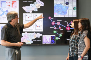 Washington University School of Medicine in St. Louis has formed a Center for Translational Bioinformatics. The goal of the center is to accelerate translational research that can improve patient care by integrating comprehensive patient data and expansive genomic datasets. Richard Head (left), the center's inaugural director, discusses data with Brittany Smith, PhD, (middle) a bioinformaticist at the center, and Ruteja Barve, PhD, (right) an assistant professor of genetics.